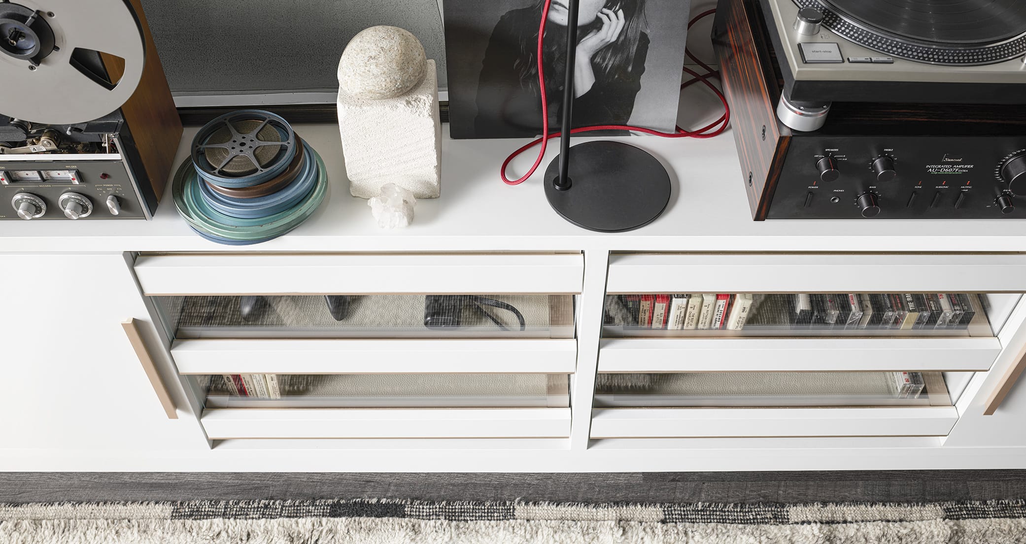 Music center with built-in entertainment center shelving in white wood finish by California Closets