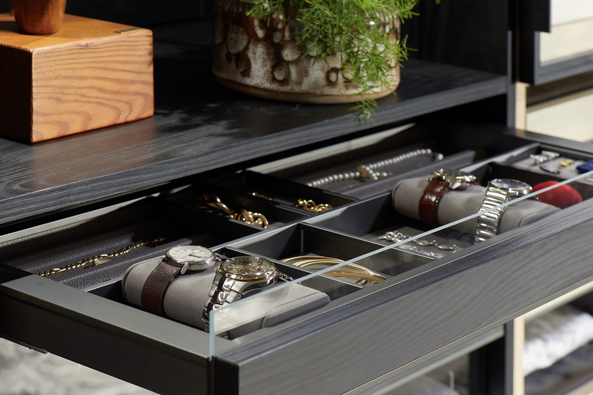 Jewelry detail inserts for watches with padded cushions in dark wood finish by California Closets