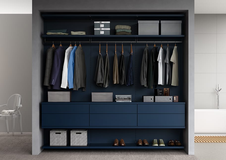 Custom closet in reach in style with vertical shelving, overhead storage and clothing poles by California Closets.